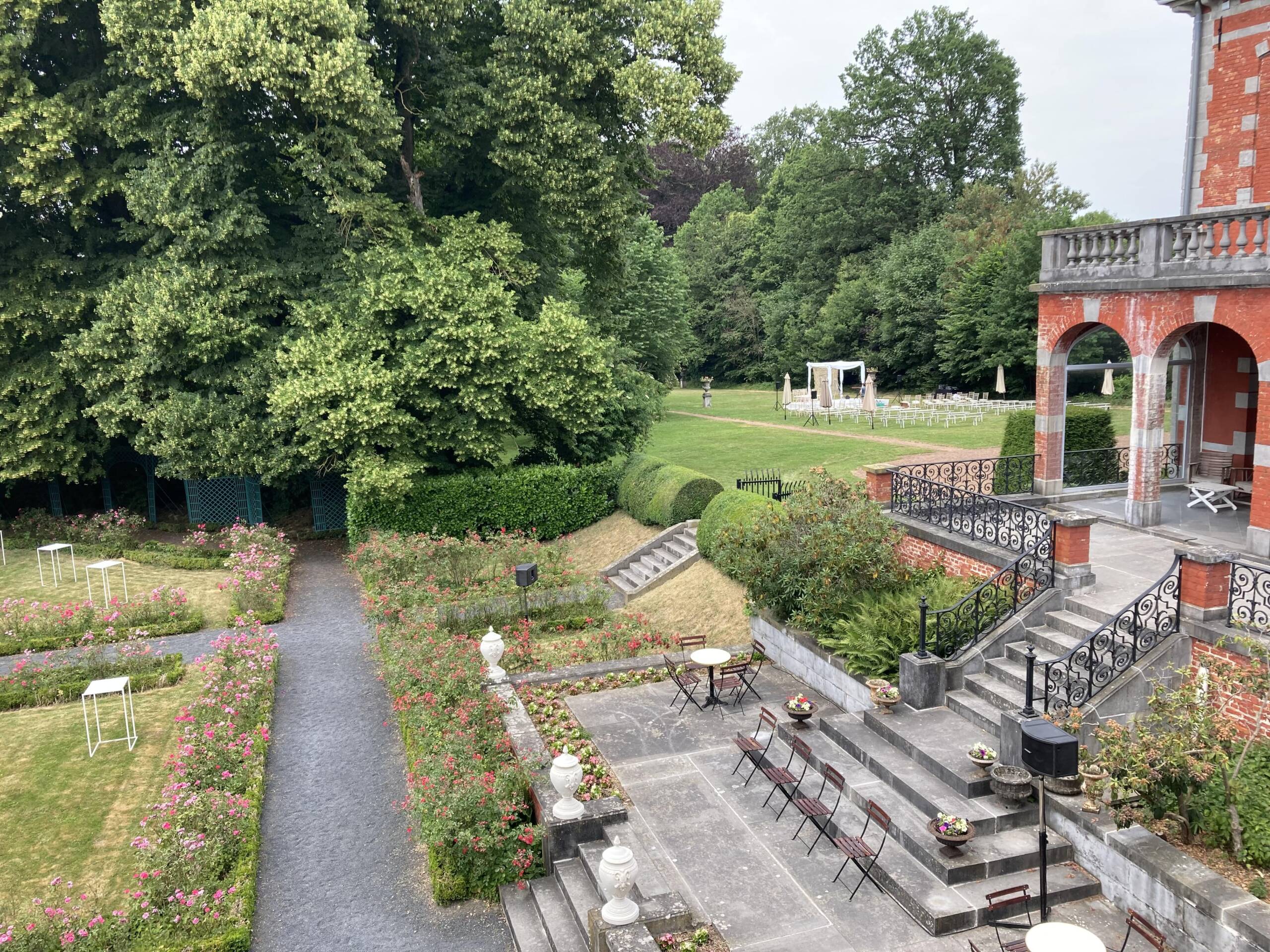 vue - jardin français réception et tapis vert derrière le château cérémonie de mariage-min